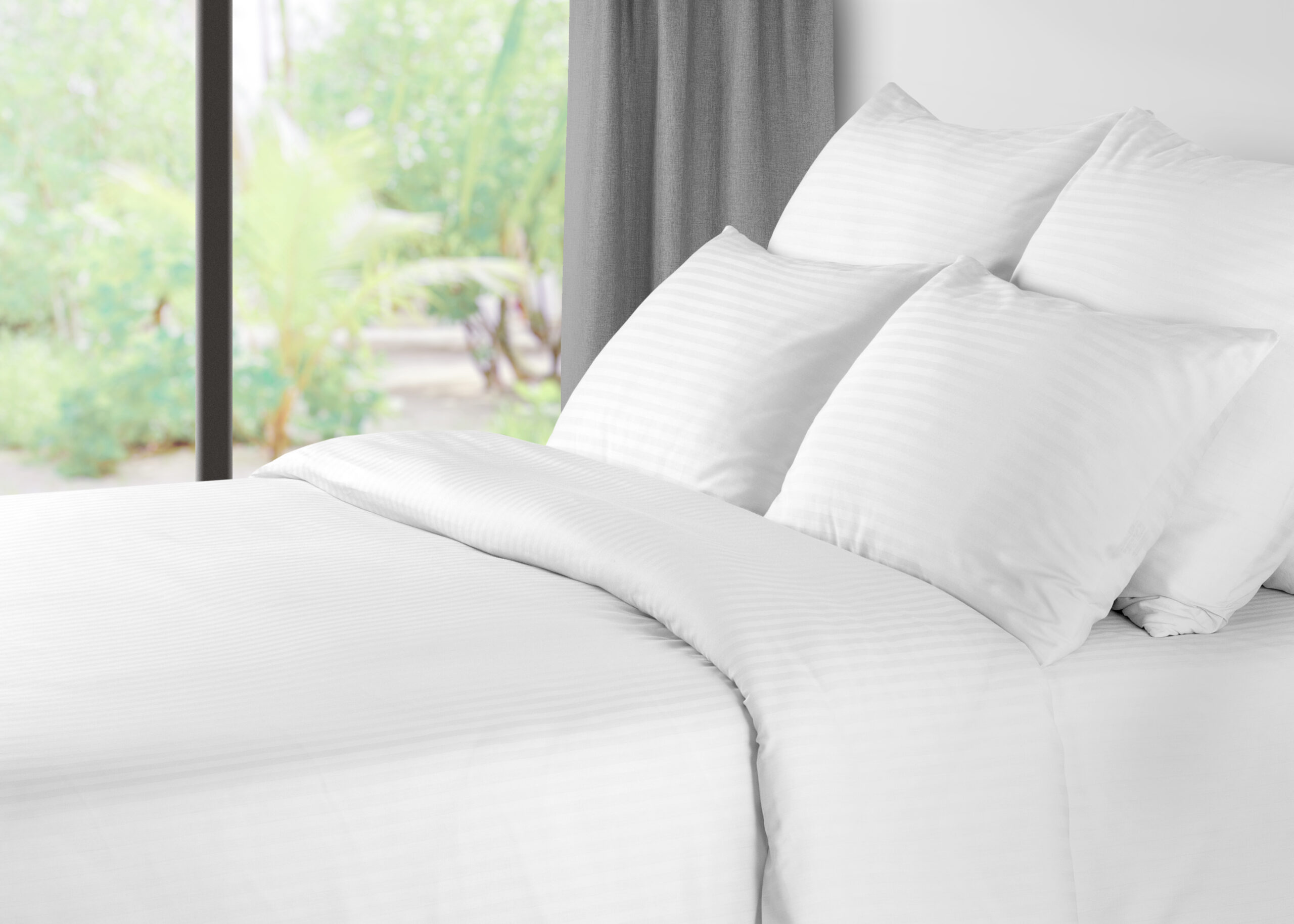 Bed with linen against a window with grey curtains Bed With Linen Against A Window With Grey Curtains